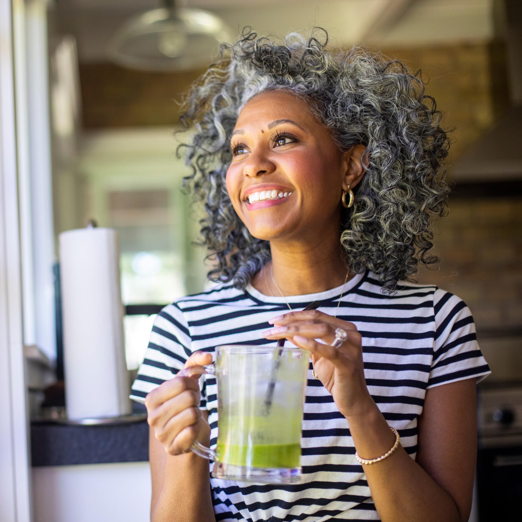 Kuli Kuli Green Power in a smoothie glass illustrating versatility for snacks.