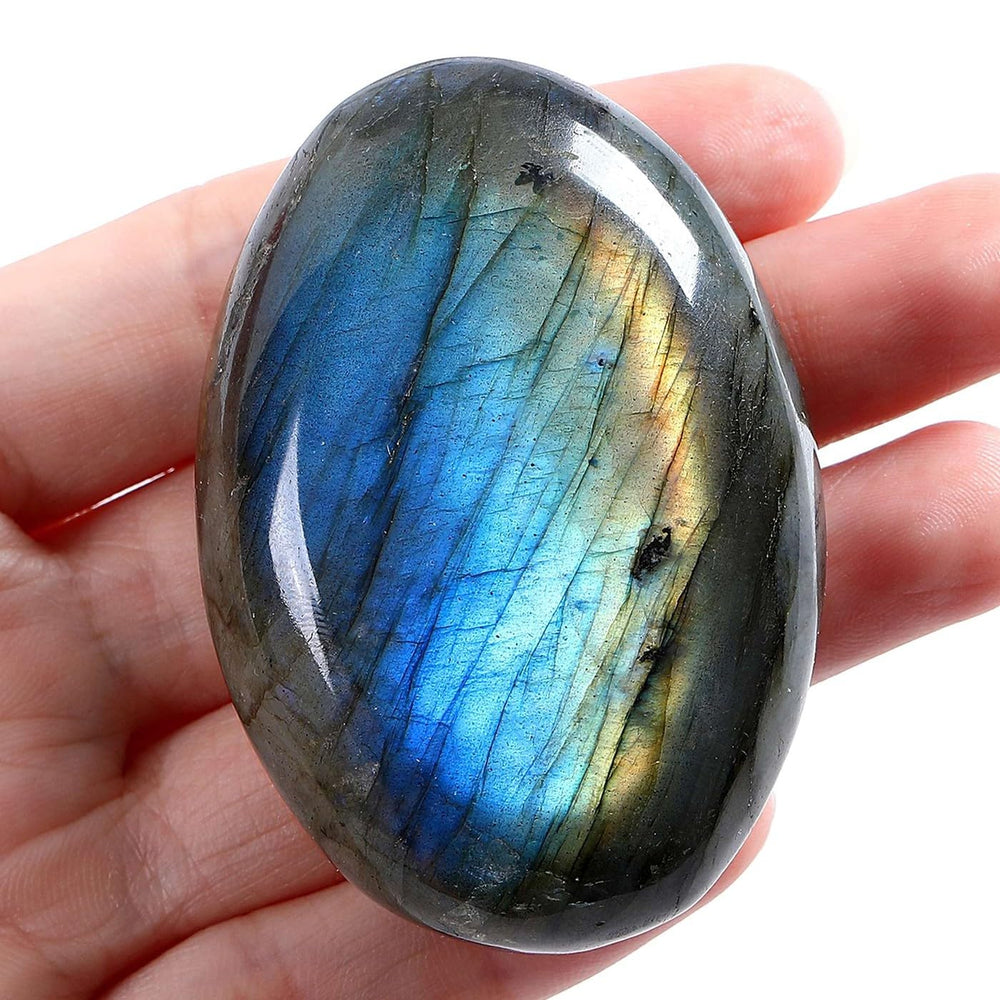 LAIDANLA Labradorite palm stone in hand highlighting portability and energy balancing on the go.