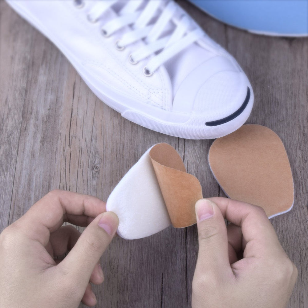 Liams Shoppe tongue pad being applied inside a shoe to prevent rubbing.
