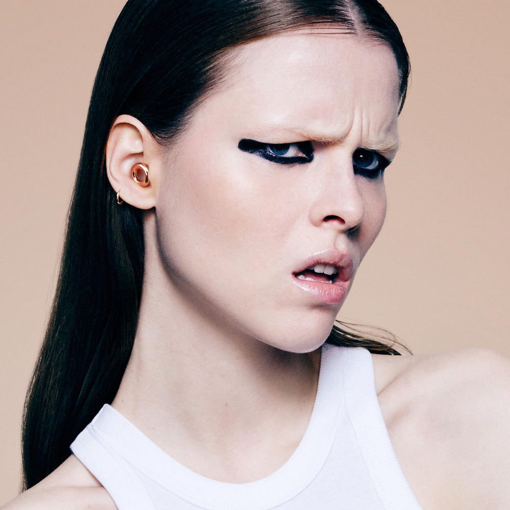 Loop Experience 2 earplugs being inserted and adjusted for optimal noise reduction