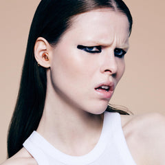 Loop Experience 2 earplugs being inserted and adjusted for optimal noise reduction