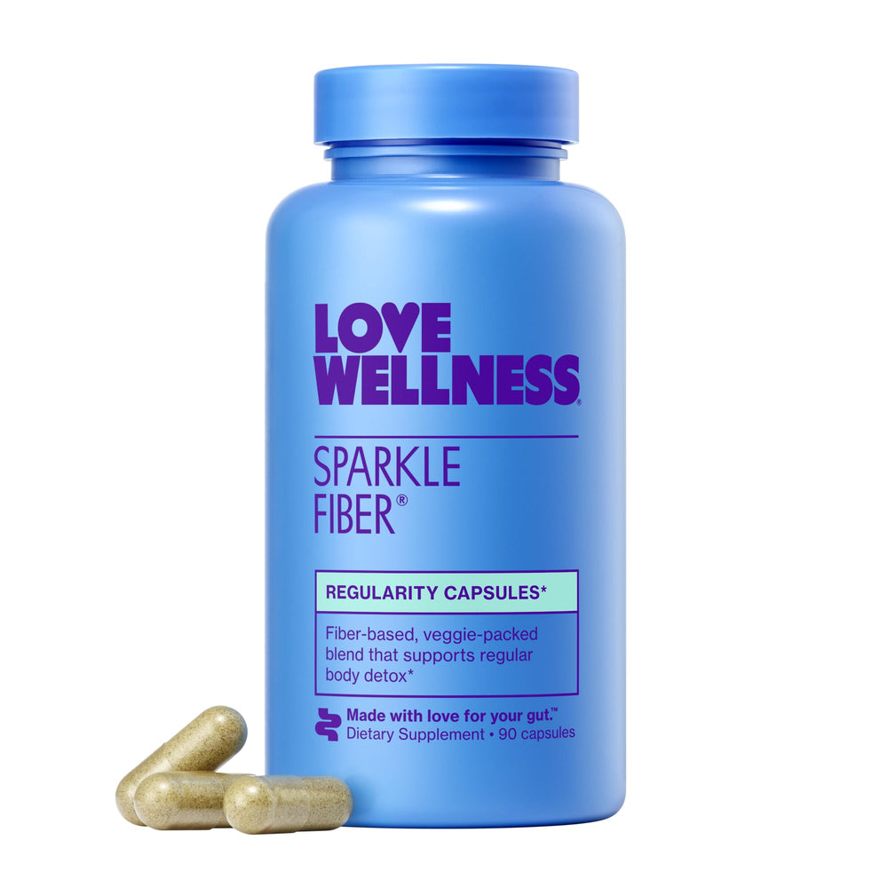 Love Wellness Sparkle Fiber bottle being poured into a glass for digestion support.