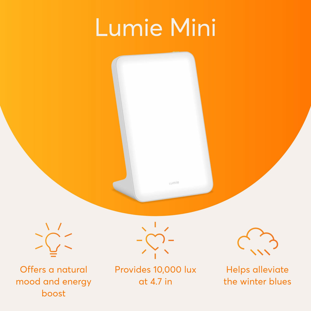 Lumie Mini Lamp angled on a bedside table for desk or dorm use with bright light
