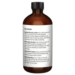 M3 Naturals castor oil pour closeup on glass bottle.