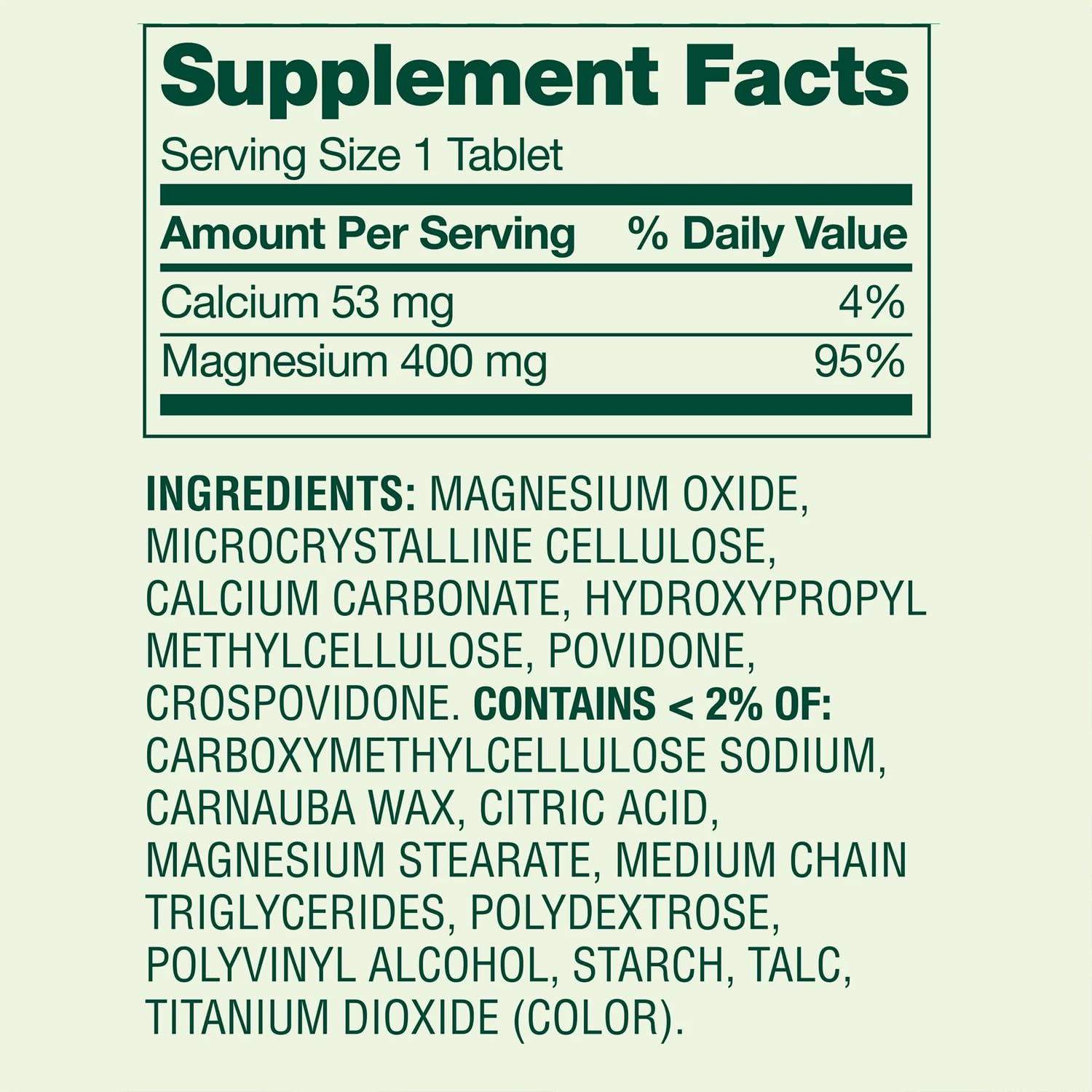 Magnesium Oxide 400mg Supplement bottle beside a glass of water