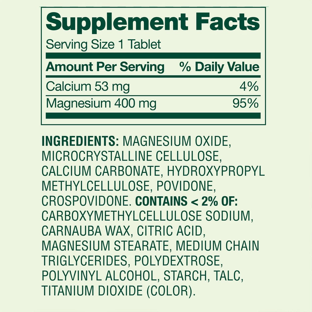 Magnesium Oxide 400mg Supplement bottle beside a glass of water