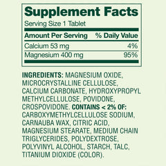 Magnesium Oxide 400mg Supplement bottle beside a glass of water