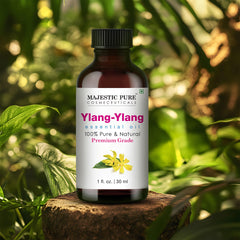 Majestic Pure Ylang Ylang oil beside diffuser for calming aromatherapy.