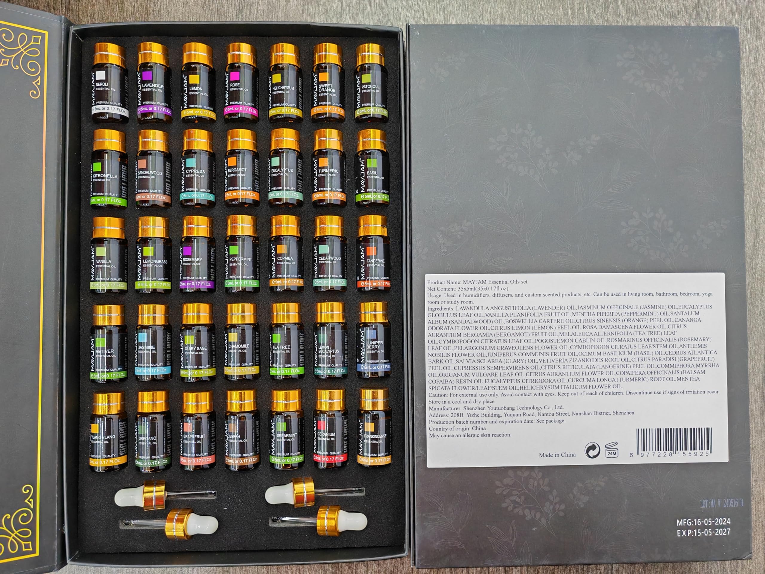 MAYJAM oil collection label closeup showcasing varied scents and colorful bottles.