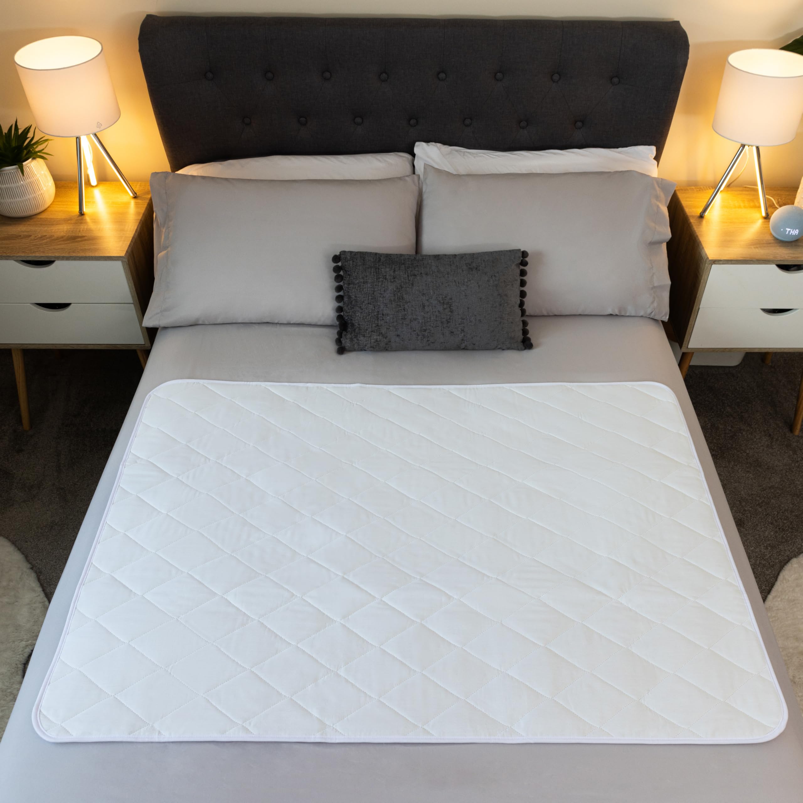 McLiberty 34x52 bed protector in use on a bed for adults