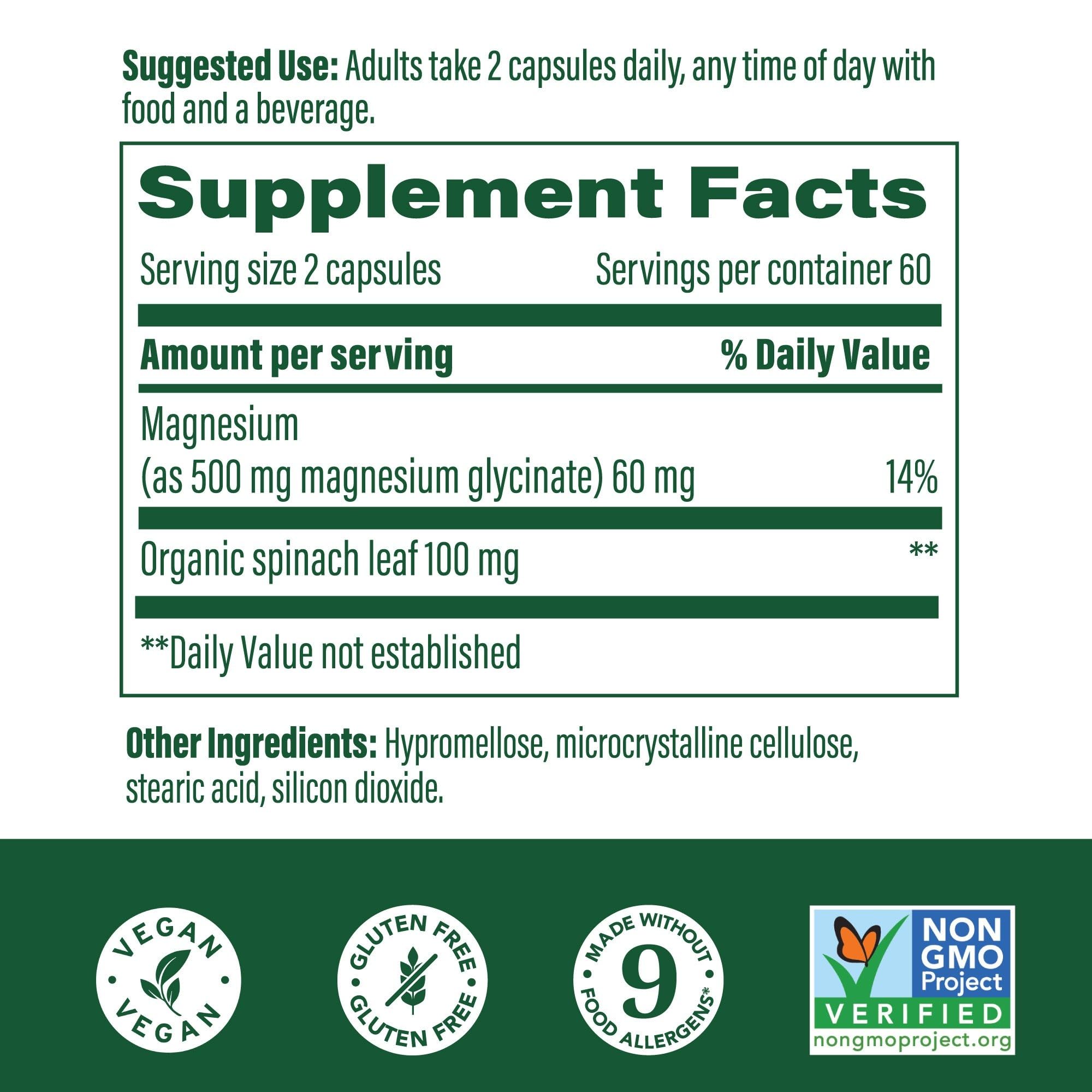 MegaFood Magnesium Glycinate capsules with a glass of water.