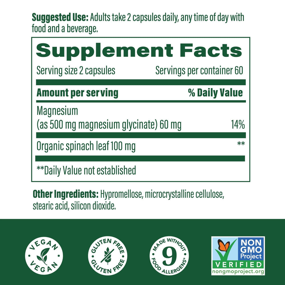 MegaFood Magnesium Glycinate capsules with a glass of water.