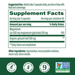 MegaFood Magnesium Glycinate capsules with a glass of water.