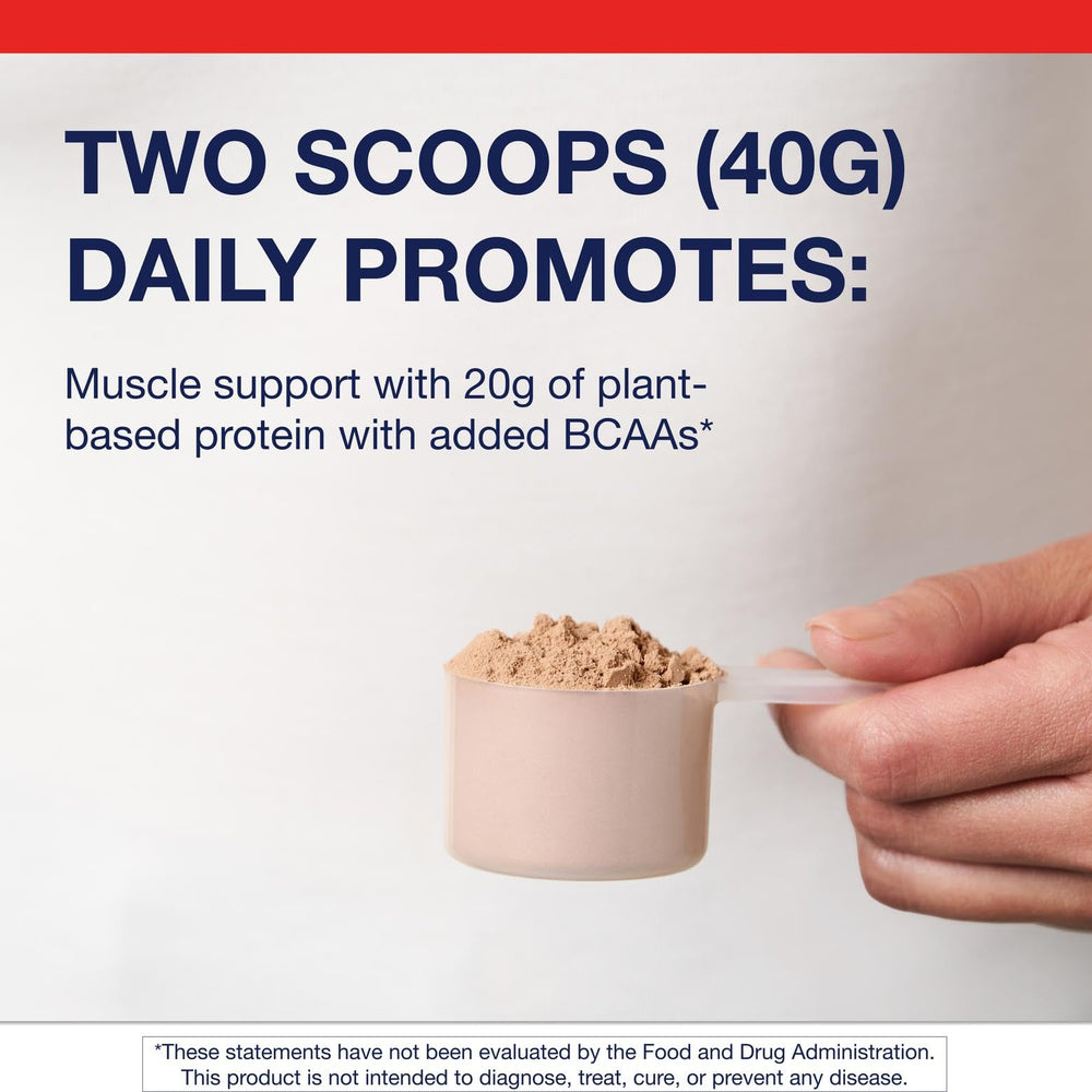 A single scoop of pea and rice protein beside a blender ready to mix.