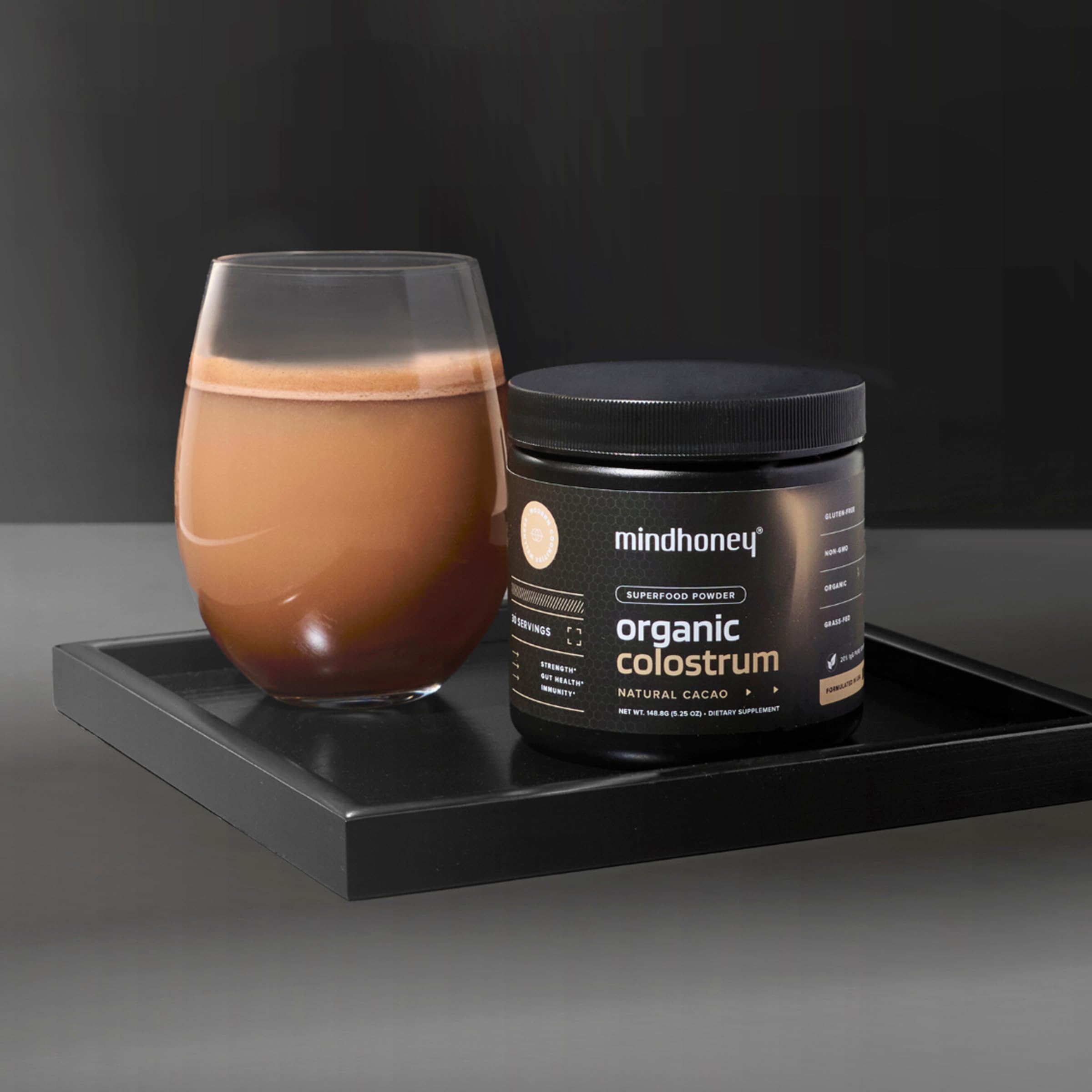 MINDHONEY Colostrum chocolate powder scoop for quick, convenient daily servings.