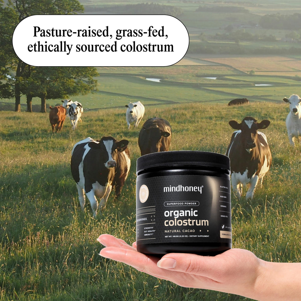 MINDHONEY Organic Colostrum smoothie glass shows chocolate blend for a tasty boost.