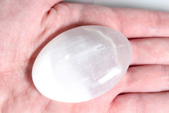 MINERALUNIVERSE white selenite crystal palm stone on desk setup.