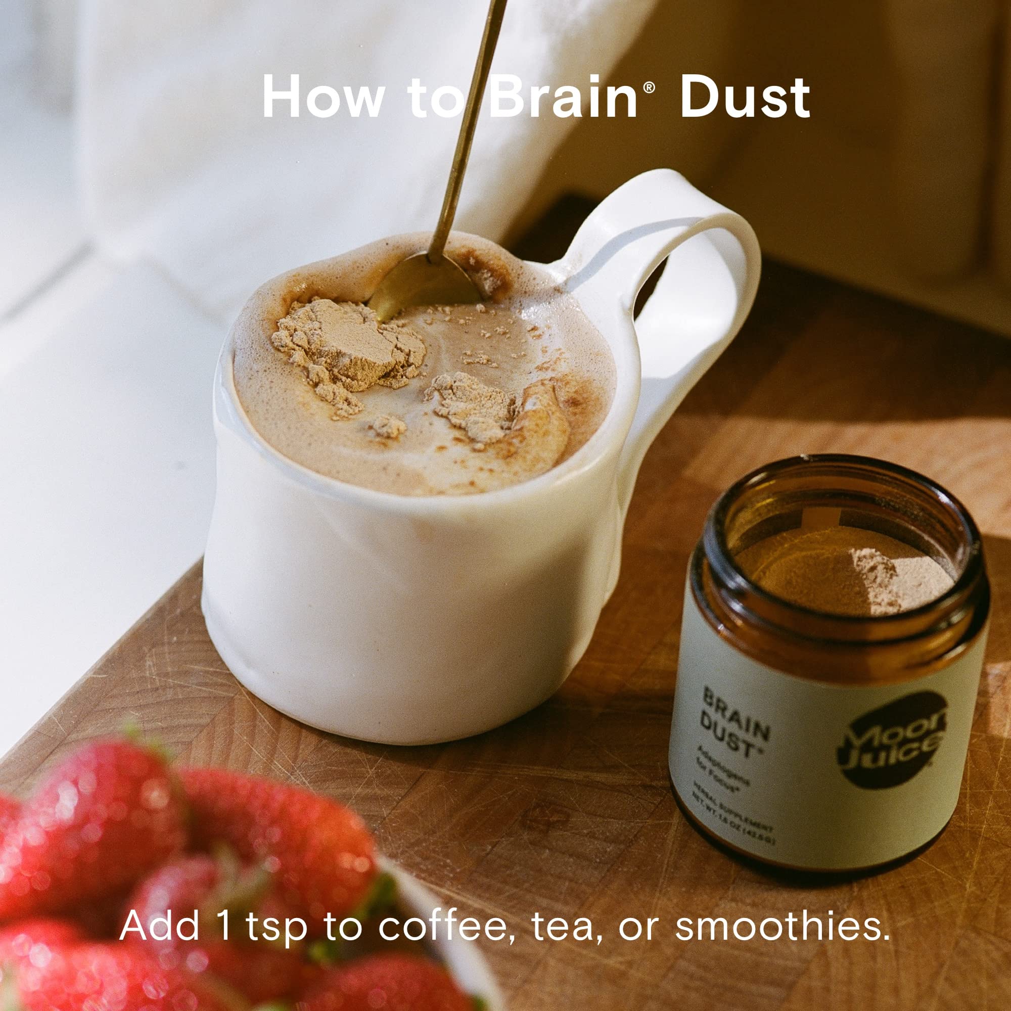 Moon Juice Brain Dust glass with drink demonstrating caffeine-free cognitive support.
