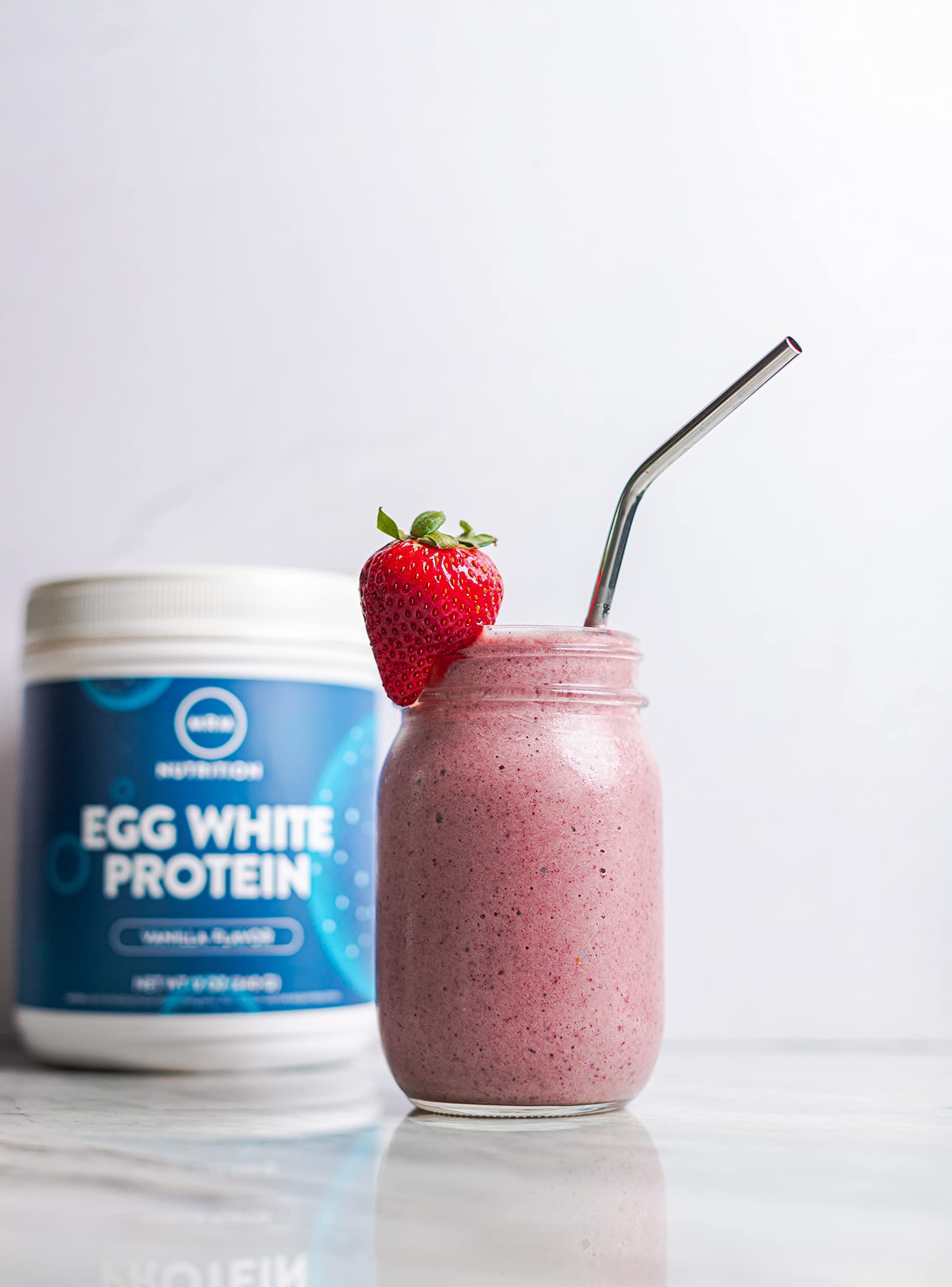 MRM Egg White Protein Vanilla powder pouring into shaker.