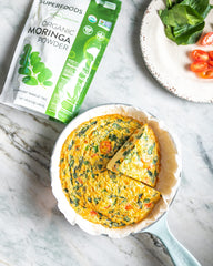 MRM Moringa powder being scooped for quick use in drinks