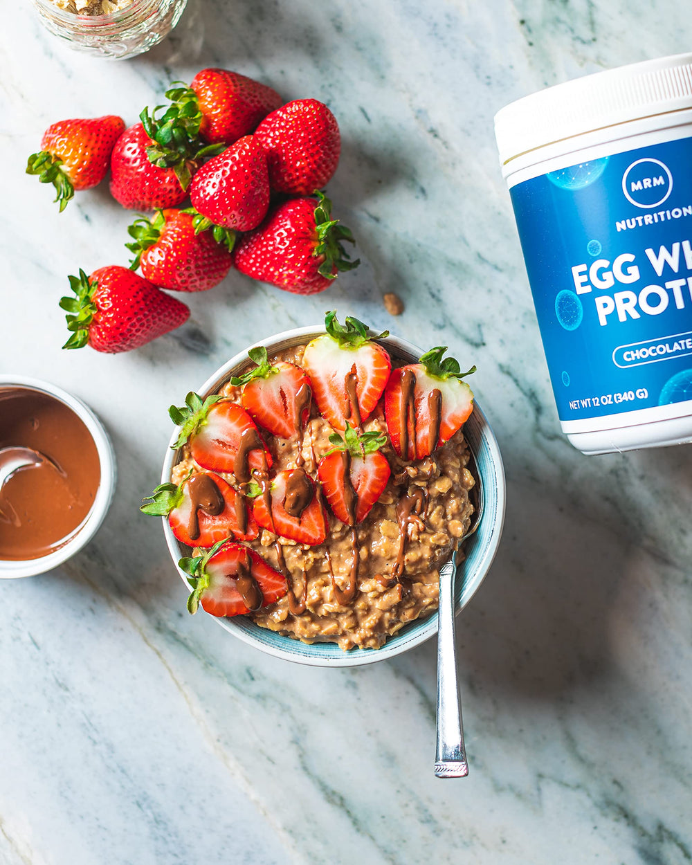 MRM Egg White Protein with scoop and measurement near ingredients.