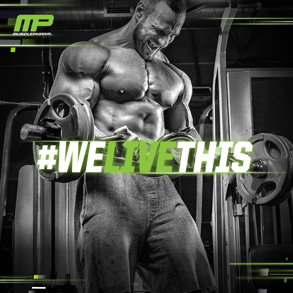 Fruit Punch flavor label on MusclePharm Essentials BCAA container in gym setting