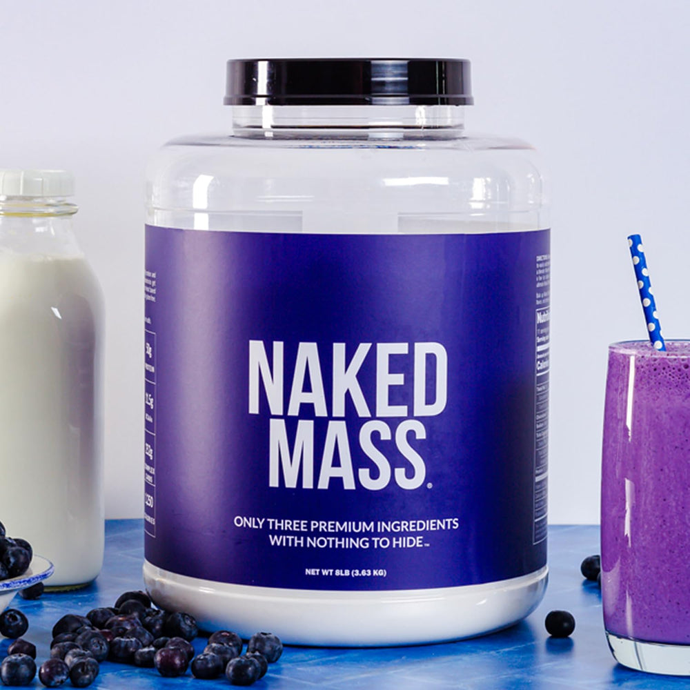 NAKED Vanilla Mass scoop resting in powder for easy daily servings.