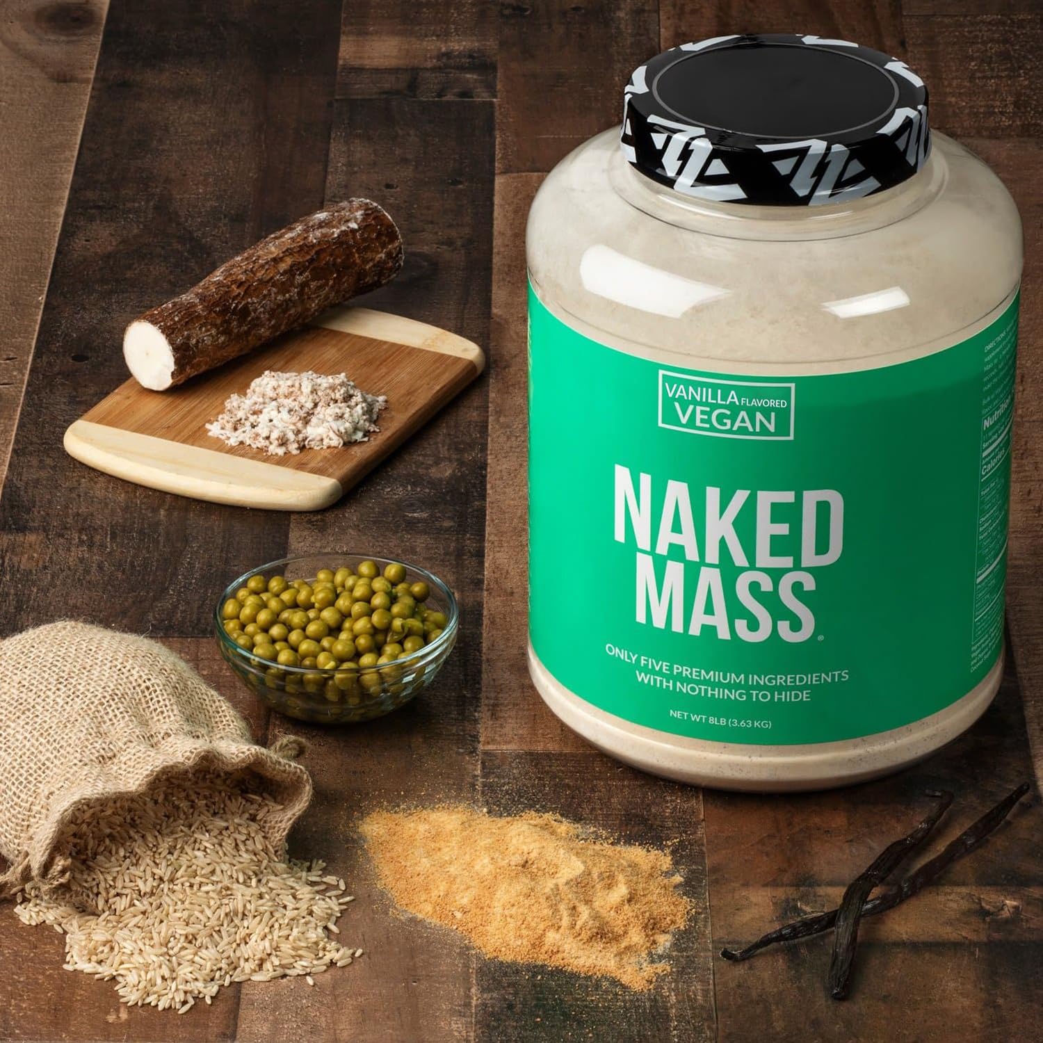 Serving scoop beside blender with NAKED Vegan Mass vanilla for on-the-go shakes