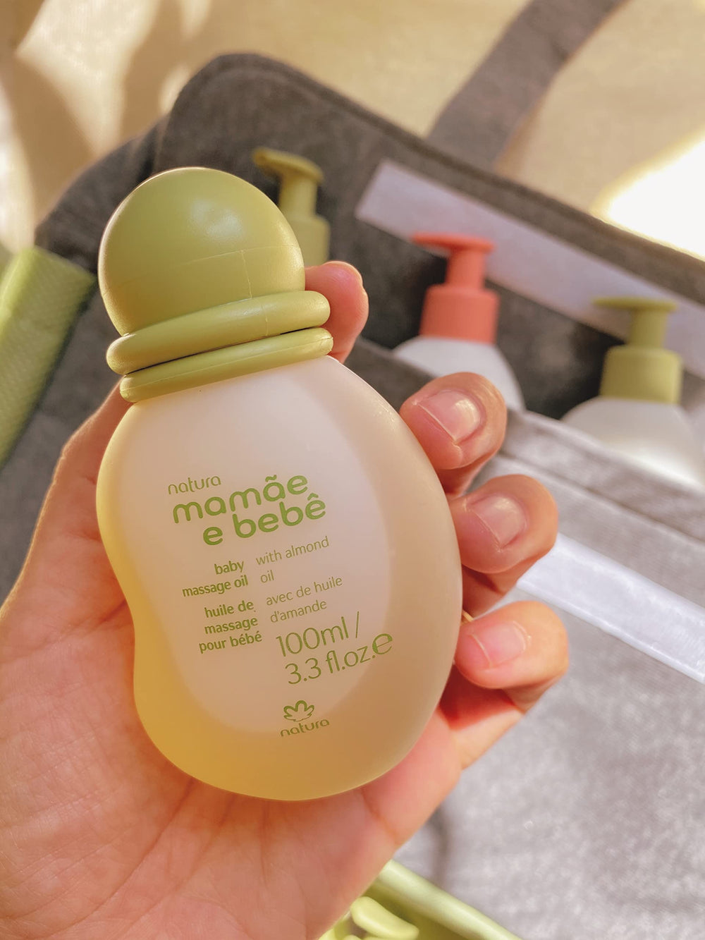 Natura Baby Massage Oil on soft baby skin demonstrates gentle, soothing feel.