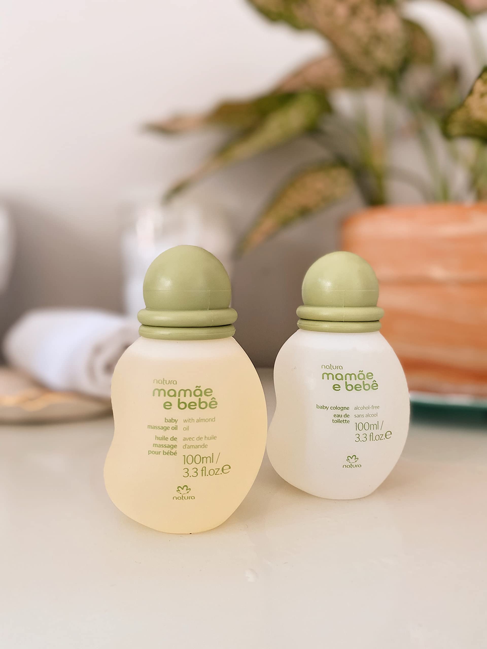 Natura Baby Massage Oil bottle with vegan and natural origin icons.