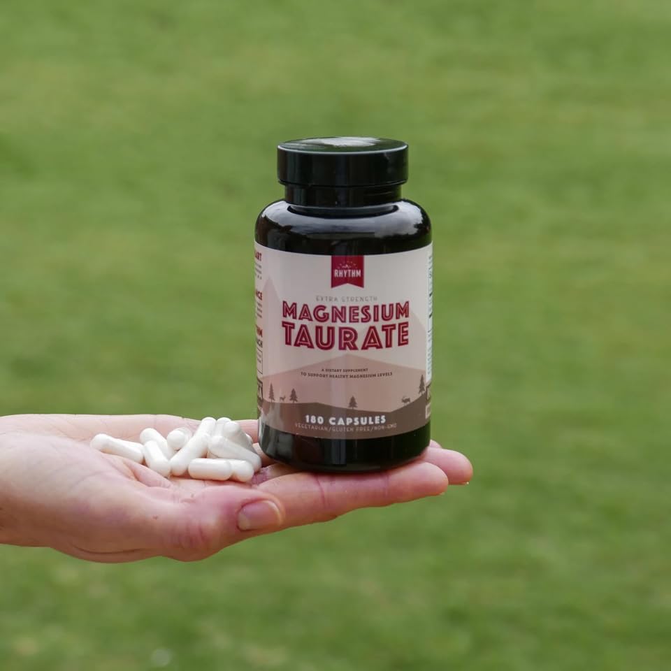 Pouring Natural Rhythm Magnesium Taurate capsules for easy dosing.