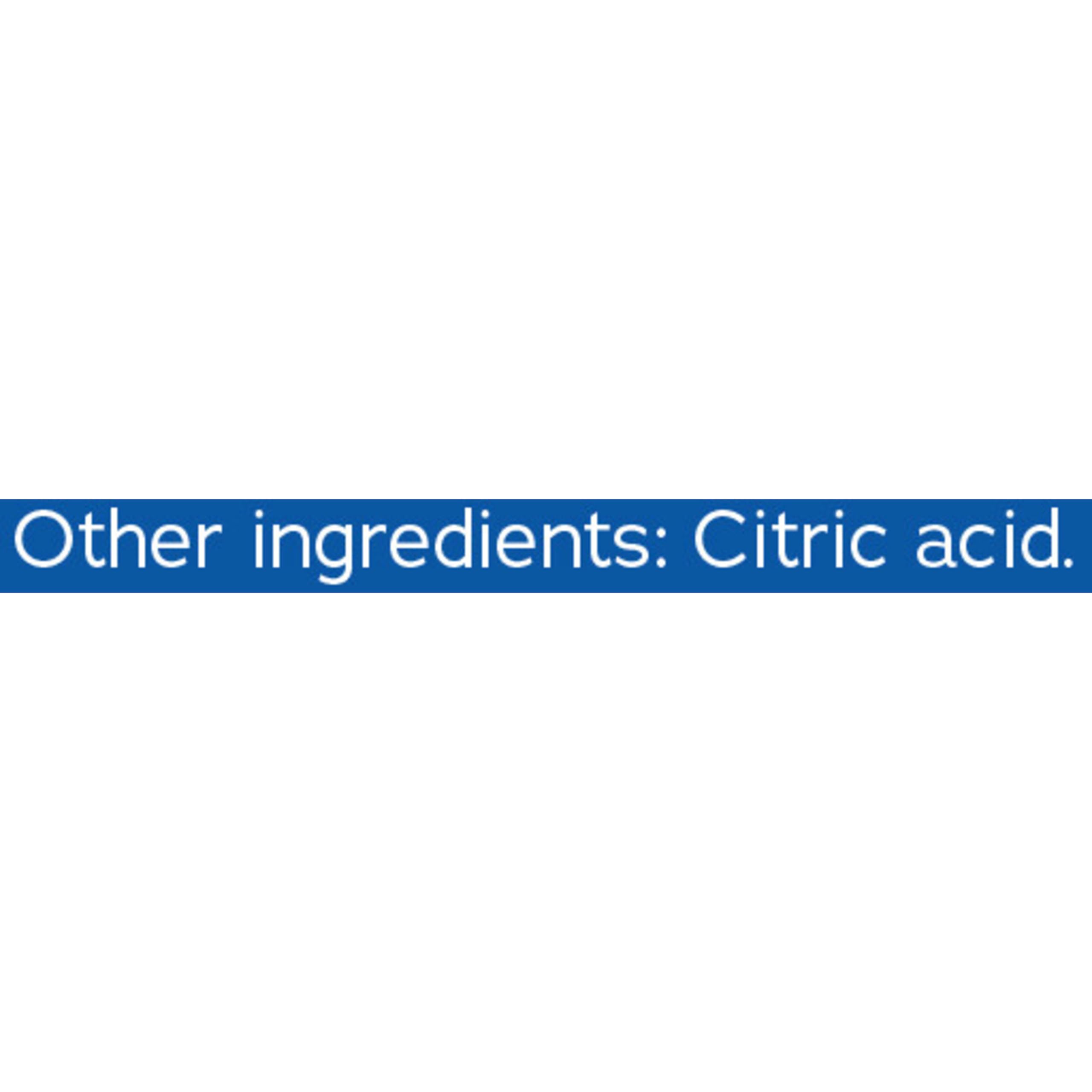 Natural Vitality CALM powder being stirred into water to create a fizzy, sugar-free drink