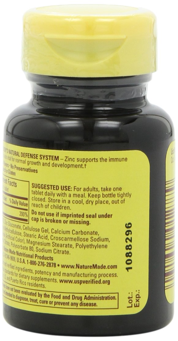 Zinc 30mg bottle beside water for daily routine.