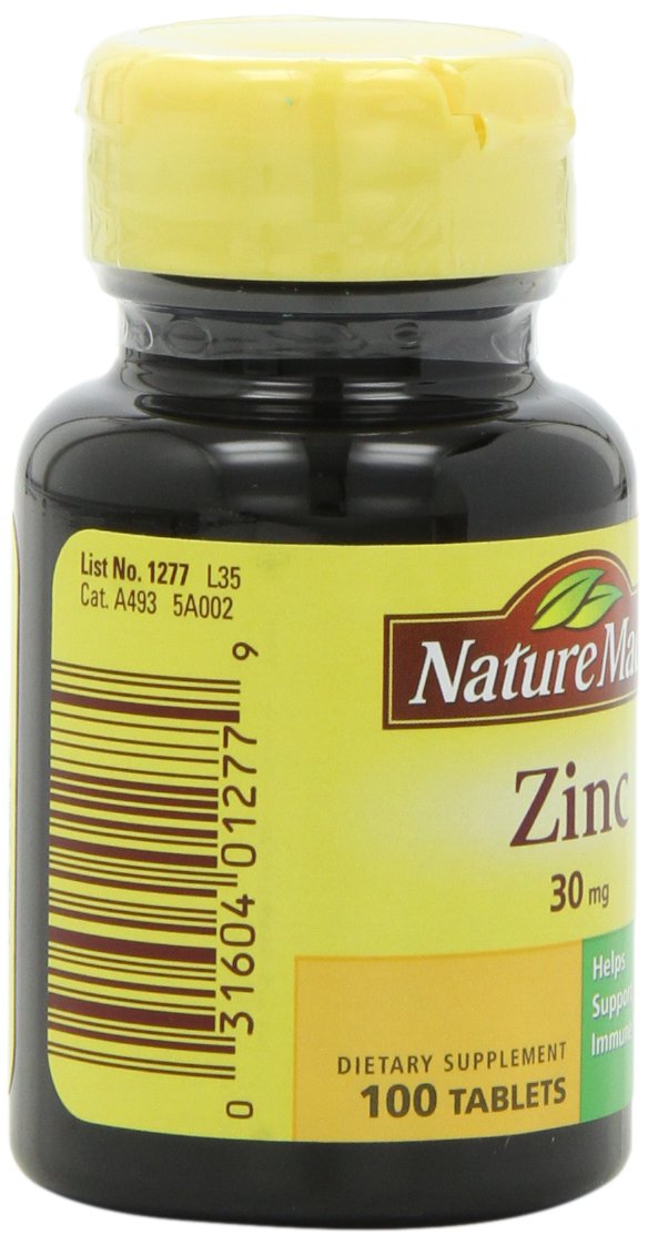 Zinc 30mg tablets on a white dish, easy to swallow.