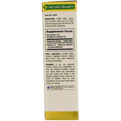 Nature's Bounty B-12 berry-flavored liquid bottle close-up highlighting no artificial colors.