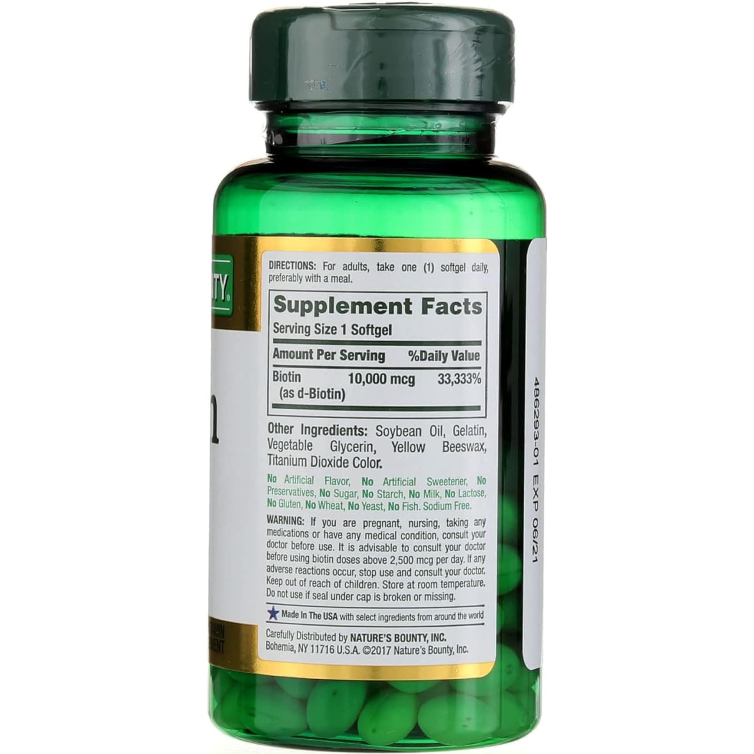Nature's Bounty Biotin bottle on a desk as part of a morning routine.