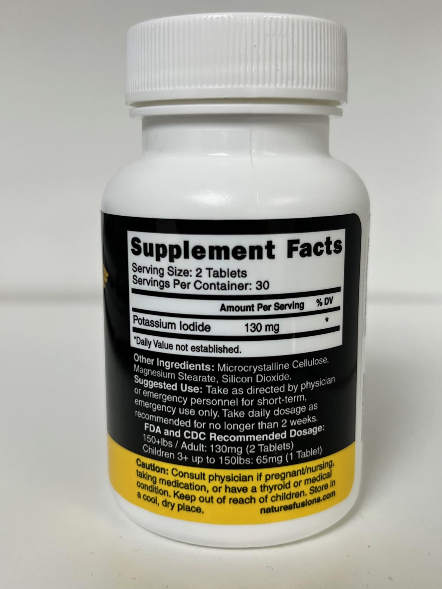 Close-up of Nature's Fusions KI tablets ready for precise dosing.
