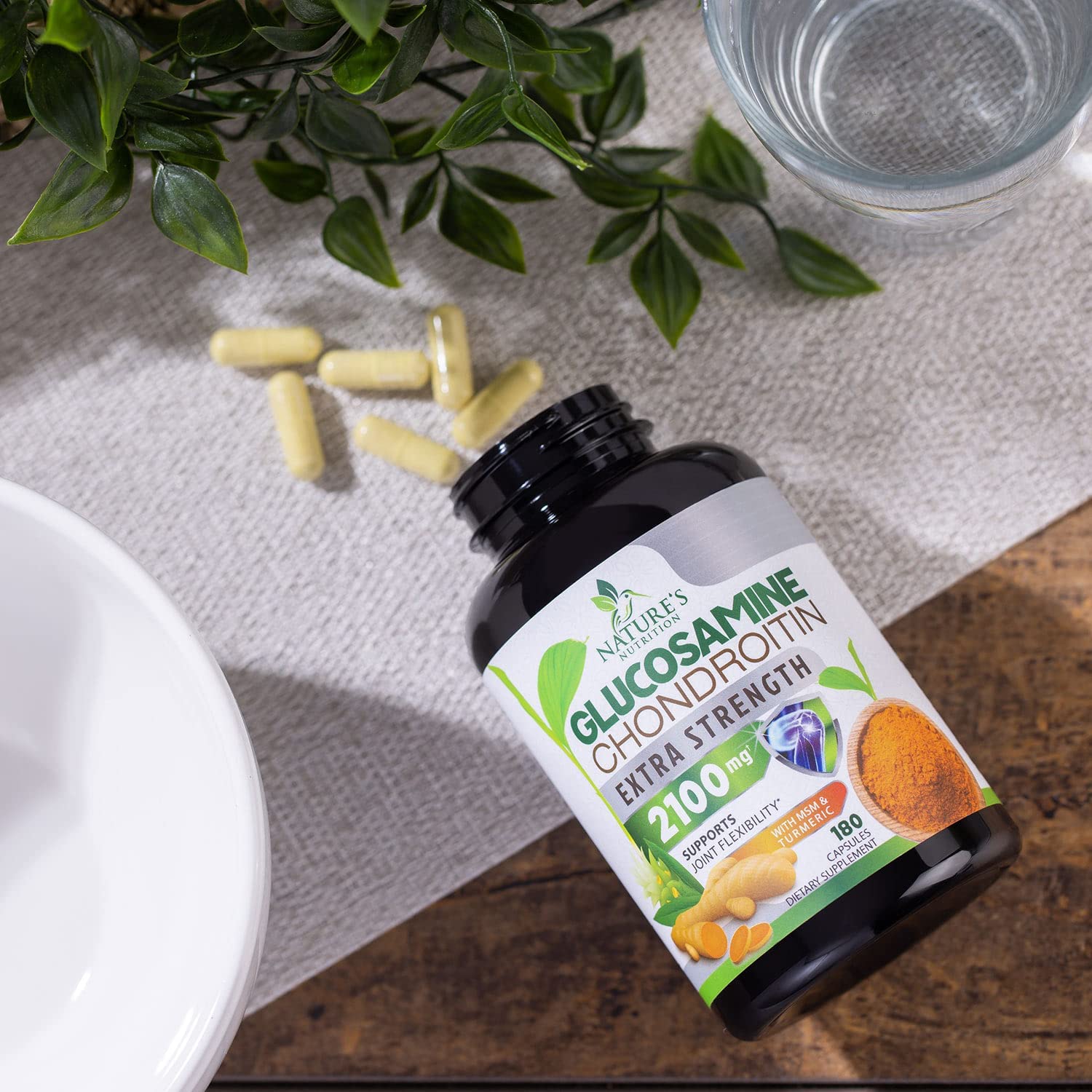 Nature's Nutrition capsules in hand for on-the-go joint support
