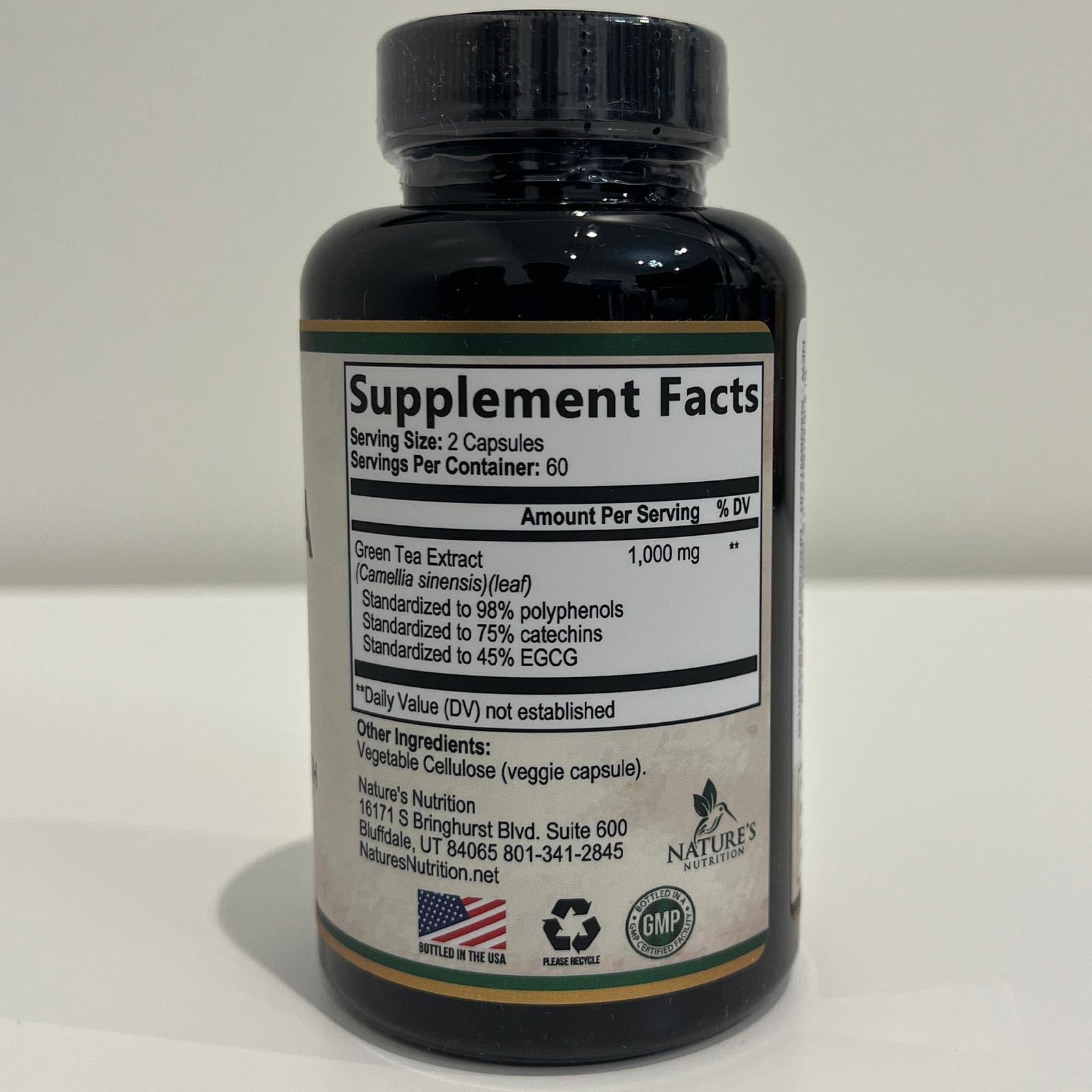 Nature's Nutrition Green Tea Extract on desk with glass of water suggesting daily ritual