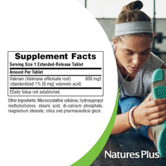 NaturesPlus valerian on a nightstand beside a glass of water for a bedtime routine.