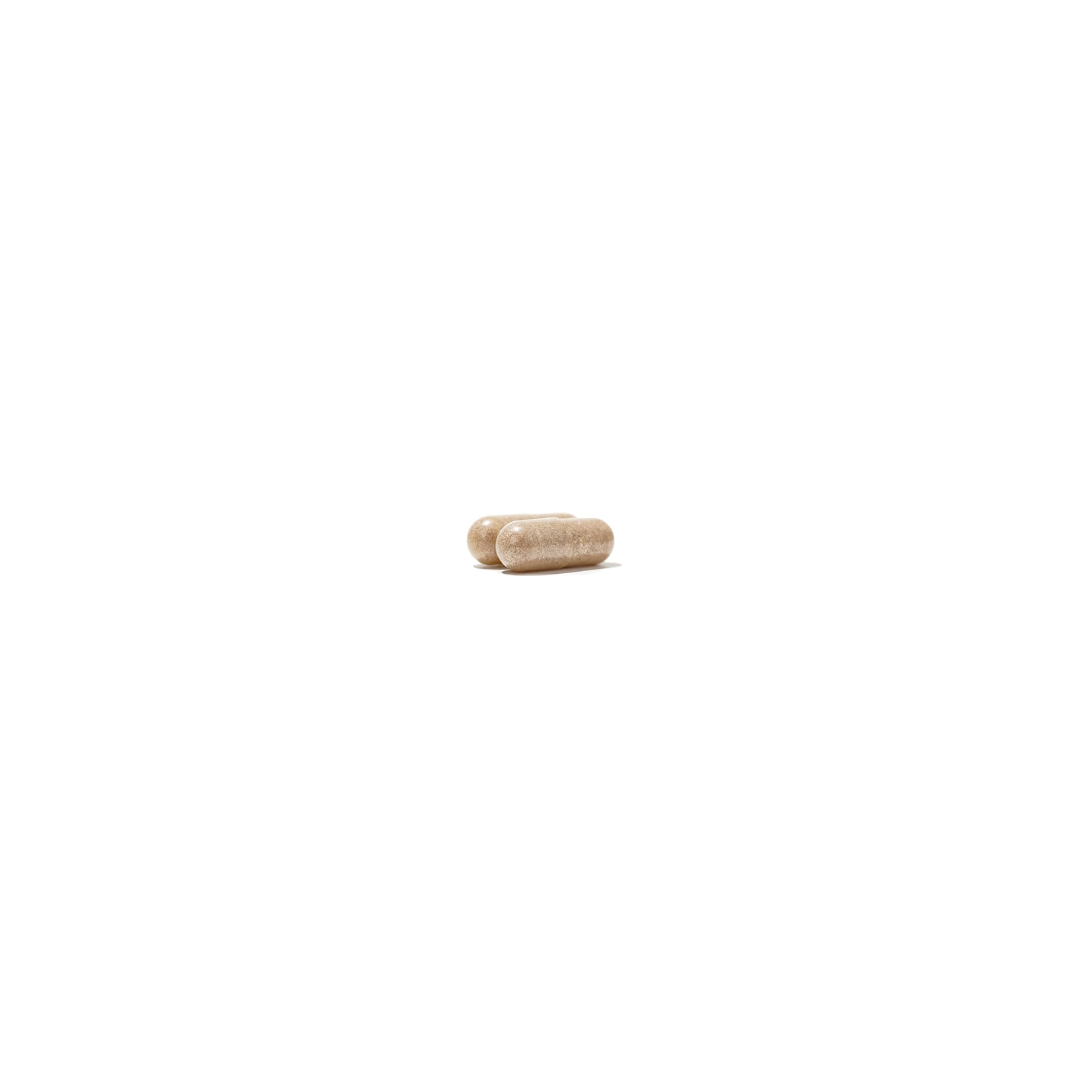 NatureWise NightTime Fitness capsule resting beside clock hints at potential sleep-friendly routine.