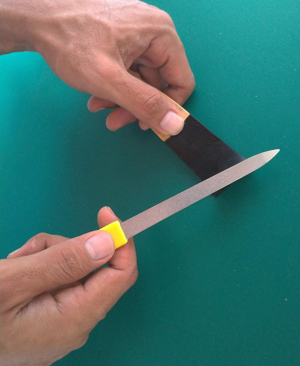 NDC Feels Like Fingernails back scratcher with nail file attachment ready to refine the tip.