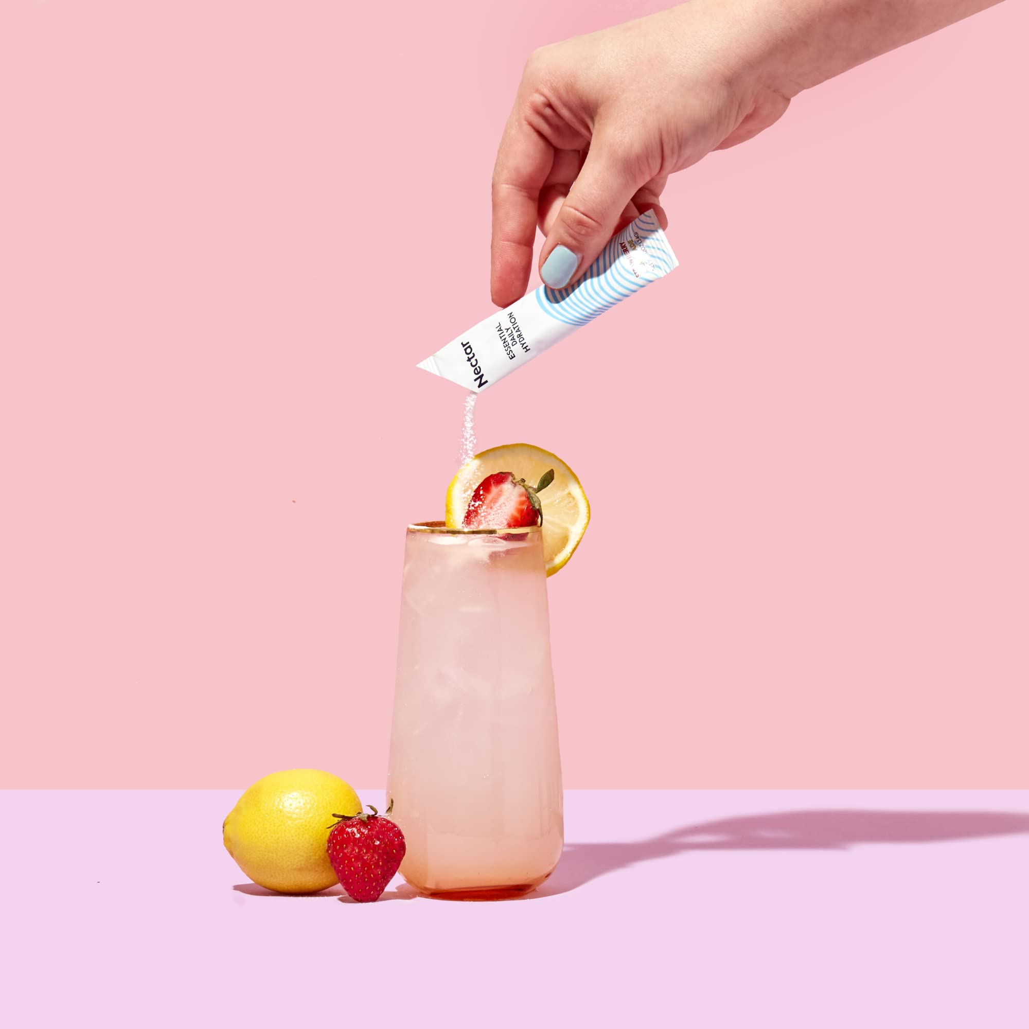 Pouring Nectar hydration powder into glass for quick hydration