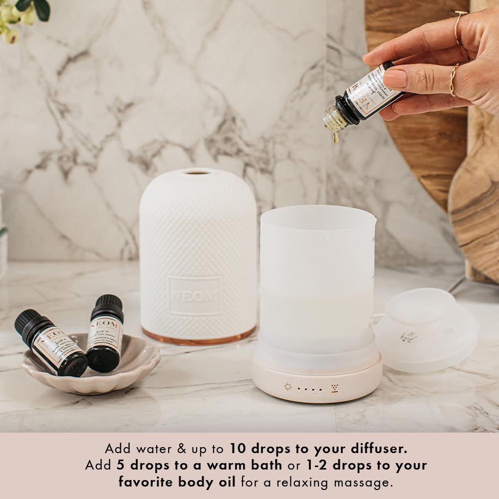 NEOM sandalwood essential oil bottle inviting grounding calm during routines.