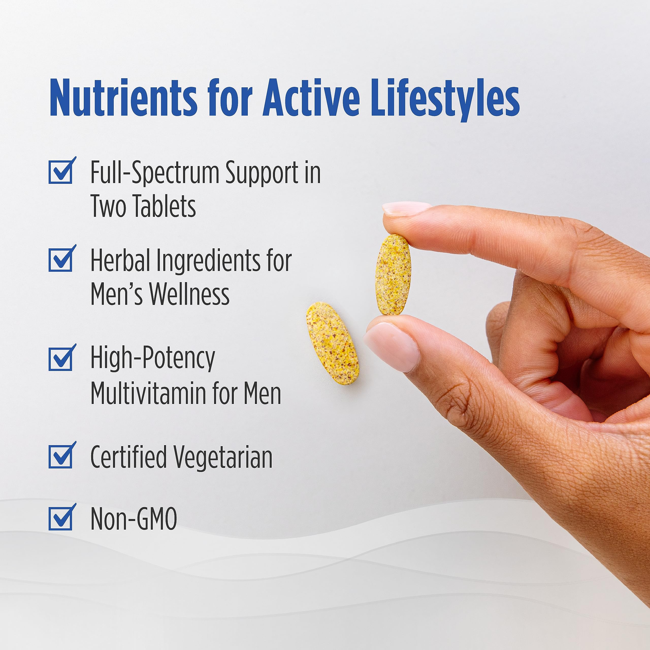 Glass of water beside Nordic Naturals Men’s Multivitamin tablets during daily intake