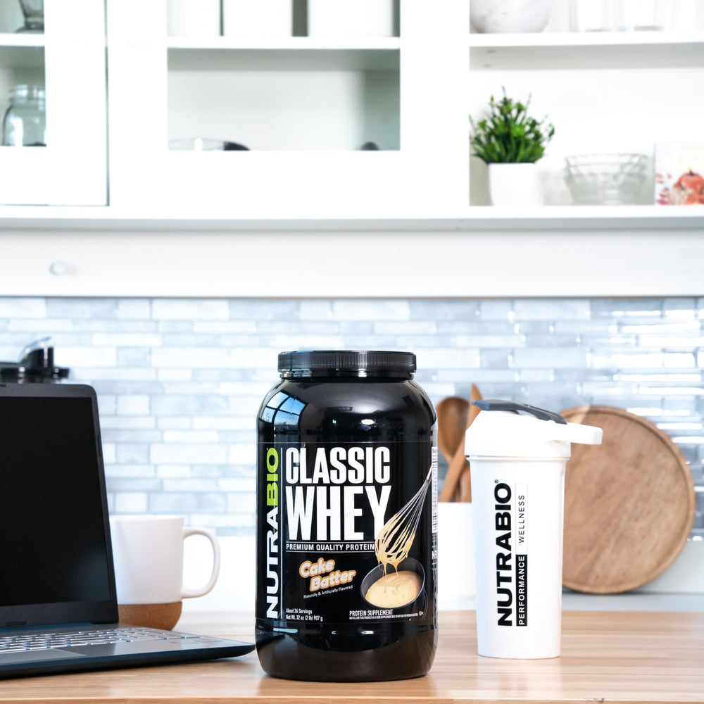 NutraBio Classic Whey Cake Batter poured into glass for tasty shake.