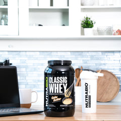 NutraBio Classic Whey Cake Batter poured into glass for tasty shake.
