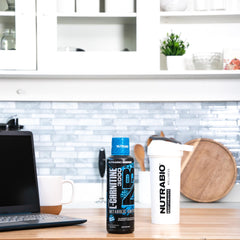 Glass with blue razz shot from NutraBio for a refreshing flavor experience.