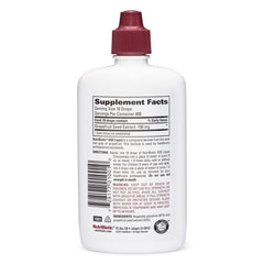 NutriBiotic GSE bottle pour demonstrates easy dosing in a glass