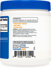 Fine Arginine AKG powder pours into a glass.